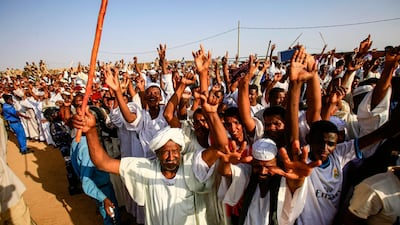Supporters of the deputy head of Sudan's ruling Transitional Military Council (TMC) and commander of the Rapid Support Forces (RSF) paramilitaries gather and cheer for him upon his arrival in the village of Qarri, about 90 kilometres north of Khartoum. AFP