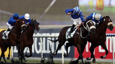 Jockey Paul Hanagan leads Soft Falling Rain, centre right, to win the Godolphin Mile in the 2013 Dubai World Cup meet, the world's richest horse race, at the Meydan race track in Dubai. AFP PHOTO/MARWAN NAAMANI