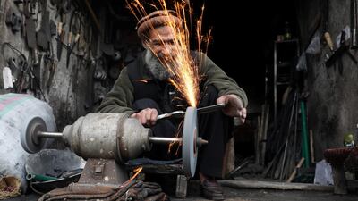 An Afghan blacksmith works at his shop in Kabul, Afghanistan. REUTERS