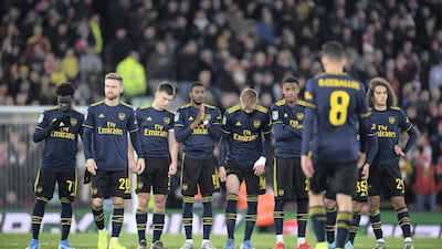 Dani Ceballos of Arsenal walks back to his teammates after having his penalty saved in the shoot-out during the League Cup game against Liverpool. Getty