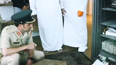 Dubai Police chief Mohammed Khalifa Al Marri inspects the safe. Police said the suspect was only able to fit Dh3 million of the estimated Dh10m in his case. Courtesy: Dubai Police
