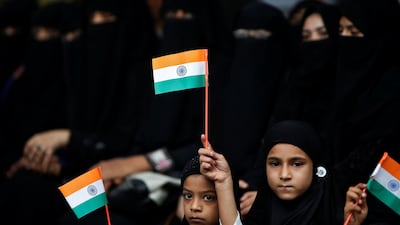 Girls hold the Indian national flags as they attend a flag hoisting ceremony in Ahmedabad. Reuters