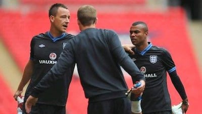 John Terry, still friends with Ashley Cole, right, has been banned for four weeks on racism charges but can appeal.