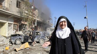 A woman stands near the site of a bomb attack in Kirkuk, Iraq on January 7, 2014. At least two people were killed and 40 others wounded when an explosive-packed lorry exploded outside a police station in the ethnically mixed city. Akoo Rasheed/Reuters