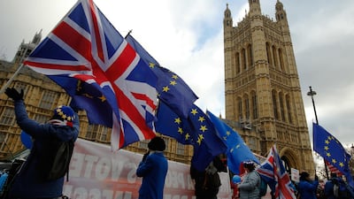 Anti-Brexit demonstrators wave EU flags and British Union flags, also known as a Union Jacks, outside the Houses of Parliament in London. Bloomberg