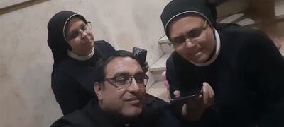 Father Youssef Asaad of the Holy Family Church and Sister Nabila Saleh, of the Rosary Sisters Gaza, listen to a phone call from Pope Francis. Photo: Holy Family Church