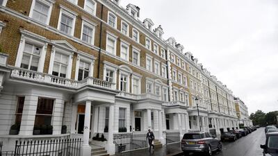A man walks along an upscale residential street in London. Hannah McKay / Reuters