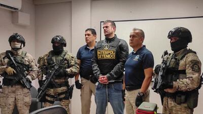 Peruvian police and Interpol agents hand over Dutch national Joran van der Sloot to the FBI in Peru on June 8. AFP