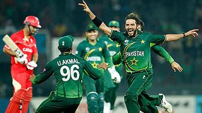 Shahid Afridi, right, celebrates the wicket of Harvir Baidwan, left, with his teammates in Colombo. Eranga Jayawardena / AP Photo