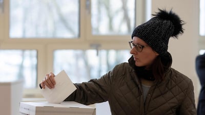 A voter casts her ballot at a polling station in Zagreb. AFP