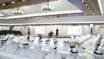 Guests and dignitaries attend a lecture by Dr Pavan Sukhdev (on stage R), titled: "Redefining wealth for an economy of performance", at Majlis Mohamed bin Zayed.