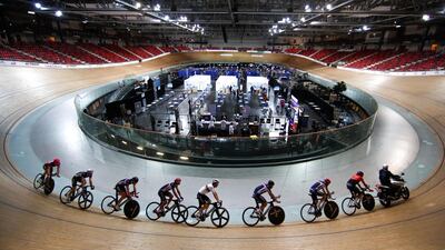 France's cycling team trains as members of the public receive Covid-19 vaccinations at the National Velodrome of Saint-Quentin-en-Yvelines, at Montigny-le-Bretonneux, south-west of Paris, France. Reuters