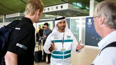Mohammed al Zaabi, a volunteer for Takatof, greets visitors arriving in Abu Dhabi for last year’s event.