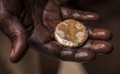 A craftsman holds a piece of gold at the gold market in Khartoum. AFP