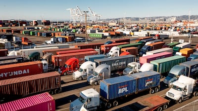 Trucks entering a Port of Oakland shipping terminal in Oakland, California last month. Prospects for a solid rebound going forward are being clouded by rising worries about Omicron. AP