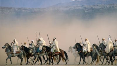 Moroccans take part in an equestrian fantasia in the desert near Marrakesh. The traditional display comes to Abu Dhabi for a week from Thursday. Tim Graham / Getty Images
