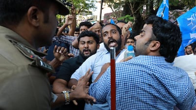 Indian police disperse activists trying to burn an effigy of Kerala's Chief Minister Pinarayai Vijayan, at a protest after two women entered the Sabarimala Ayyapa temple. AFP