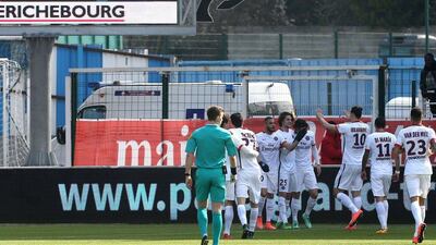Paris Saint-Germain’s teammates celebrate after Paris Saint-Germain’s French midfielder Adrien Rabiot (5th L) scored his side’s third goal during the French Ligue 1 football match between Troyes and Paris Saint-Germain on March 13, 2016 at the Aube Stadium in Troyes. PHOTO AFP / FRANCOIS NASCIMBENI