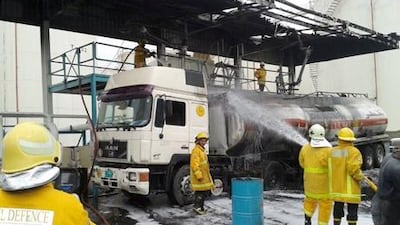 Fire crews putting out a fire at a diesel depot in Hamriya Free Zone, Sharjah. Yasin Kakande / The National