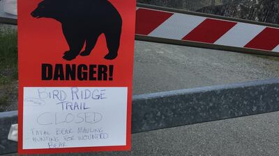 A sign warns people that the trail head is closed after a fatal bear mauling at Bird Ridge Trail in Anchorage, Alaska. Mark Thiessen / AP Photo