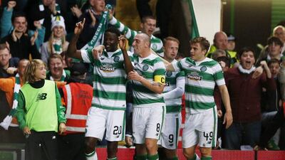 Dedryck Boyata, left, celebrates with team mates after scoring the first goal for Celtic. Russell Cheyne / Reuters