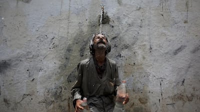 While the provincial government announces a public holiday to encourage people to remain indoors, those outdoors use public taps to keep cool off as the heatwave in Pakistan claims nearly 700 lives. Akhtar Soomro / Reuters;