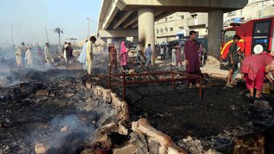 The fire reduced the dwellings along the Lyari River, in the Teenhatti neighbourhood, to debris. EPA