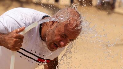 A man cools himself with water, amid a heatwave in Al Fayoum Governorate, southwest of Cairo. Reuters