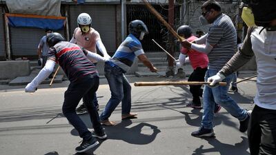 Plain clothes policemen wield their batons against a man for defying the lockdown imposed by the government to slow the spreading of coronavirus disease at Howrah on the outskirts of Kolkata, India. Reuters