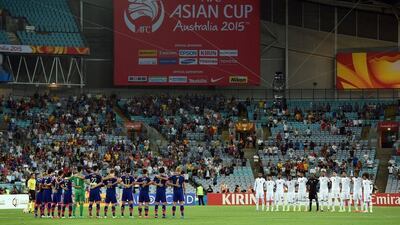 Japan and the UAE line up for national anthems prior to their Asian Cup quarter-final match on Friday. Saeed Khan / AFP