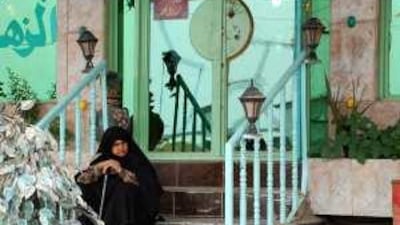 An Iranian woman sits outside her hotel in Karbala, Iraq. Millions of Iranians travel to the holy city each year, bringing money and influence.