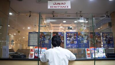 Foreign workers from the developing world transferred $404 billion to their home countries last year. Razan Alzayani / The National