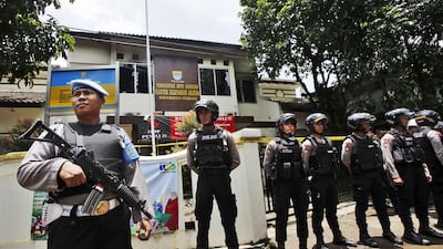 Police officers stand guard outside a municipal building after a stand off between a suspected militant and anti-terrorist police in Bandung, West Java, Indonesia. Khairizal Maris / AP Photo