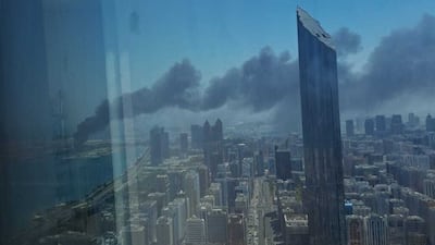 Black smoke rises from Mina Zayed, where emergency teams have contained the blaze