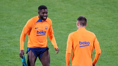 Barcelona's Samuel Umtiti, left, and Clement Lenglet warm up. AP Photo