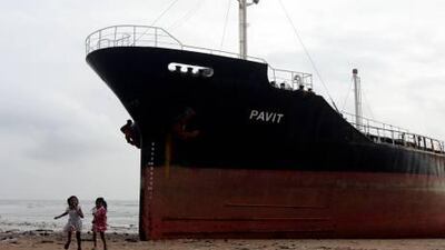 Indian children run after touching MT Pavit, an unmanned Panama-flagged cargo vessel,that ran aground at Juhu beach on the Arabian Sea coast in Mumbai.