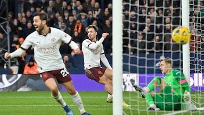 Manchester City's Jack Grealish, centre, and Bernardo Silva celebrate their second goal. AFP