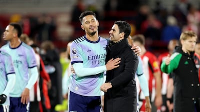 Arsenal manager Mikel Arteta, centre right, congratulates William Saliba after the win at Brentford. Getty Images