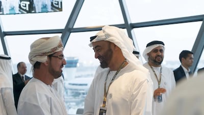 Sheikh Mohamed bin Zayed, Crown Prince of Abu Dhabi and Deputy Supreme Commander of the UAE Armed Forces (R) and Dr Khaled Saeed Salem Al Jaradi, Ambassador of Oman to the UAE (L), attend the final day of Formula 1 Etihad Airways Abu Dhabi Grand Prix, at Shams Tower. Seen with Sheikh Theyab bin Mohamed bin Zayed, Chairman of the Department of Transport, and Abu Dhabi Executive Council Member (back R). Rashed Al Mansoori / Ministry of Presidential Affairs