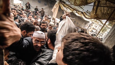 People push forward at a food distribution point of the United Nations World Food Programme in Aleppo, Syria. The WFP has money enough for just about another month. Jan-Niklas Kniewel / EPA