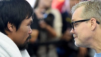 Manny Pacquiao and trainer Freddie Roach speak on Wednesday during the media workout session in anticipation of the May 2 fight with Floyd Mayweather. Harry How / Getty Images / AFP