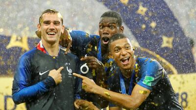 Antoine Griezmann, Paul Pogba and Kylian Mbappe celebrate after France won the 2018 World Cup. Kai Pfaffenbach / Reuters