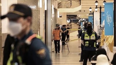 Police officers cordon off the scene of a stabbing near a subway station in Seongnam, South Korea. AP