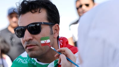 An Iran fan has his face painted ahead of the clash with Wales. Reuters