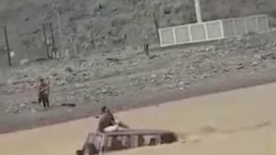 A man stranded on the roof of his car was rescued from a flood-hit wadi in Ras Al Khaimah. Courtesy: RAK Police