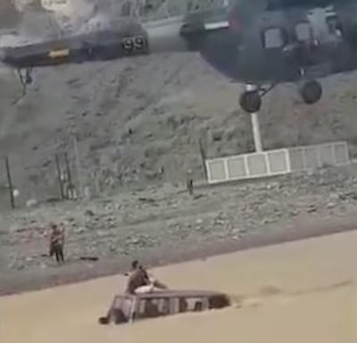 A man stranded on the roof of his car was rescued from a flood-hit wadi in Ras Al Khaimah. Courtesy: RAK Police