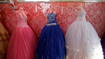 Small bridal gowns and engagement dresses are displayed in a small shop in the Zaatari camp for Syrian refugees in northern Jordan. AP