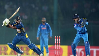 A brilliant century knock by Sri Lanka’s Kumar Sangakkara put in shade the 94 runs by India’s Shikhar Dhawan, background, as the left-hander steered his side to victory on Friday, February 28. Dibyangshu Sarkar / AFP