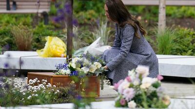 Kate lays flowers at the Glade of Light memorial garden. AP Photo