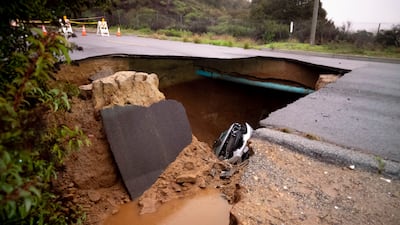 Cars in a sinkhole along Iverson Road in Chatsworth. The Orange County Register / AP